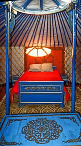 the large bed of the blue yurt in the finistère south. Yurts in Brittany: the room of the blue yurt